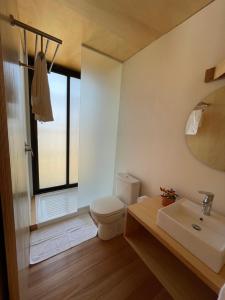 a bathroom with a toilet and a sink and a mirror at CABITO La Paloma in La Paloma +96 photos