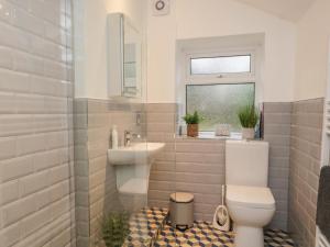 a bathroom with a toilet and a sink at Green Stile Cottage in Windermere +21 photos