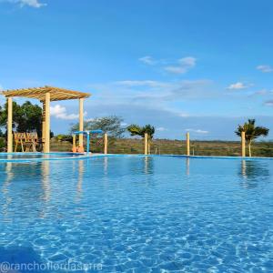 a woman is sitting in a swimming pool at Rancho Flor da Serra in Piranhas
