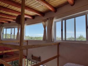 a room with large windows in a house at Cosmos Tiny House in San Marcos Sierras +17 photos