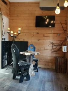 a room with a table and a chair and a tv at Sortilège in Lambesc