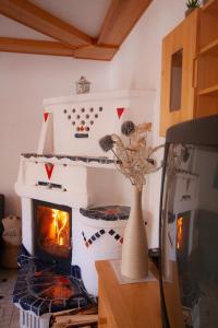 a living room with a fireplace and a vase of flowers at Appartement Heidi by Schladmingurlaub in Ramsau am Dachstein