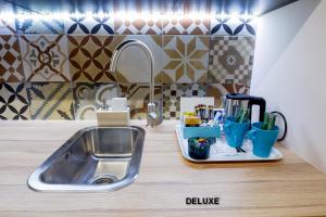 a kitchen counter top with a sink and a sink at Apartamenty Centrum z wanną dwuosobową in Piotrków Trybunalski +31 photos