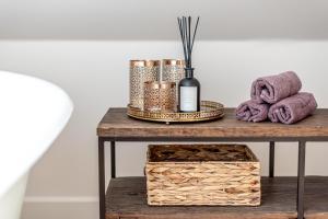 a table with towels and a bottle of wine at Luxury Gaono in Old Town in Vilnius +49 photos