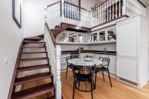 a kitchen with a staircase and a table and chairs at Luxury Gaono in Old Town in Vilnius