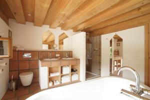 a bathroom with a bath tub and a sink at Ansitz Parstorfer in Chieming