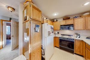 a kitchen with wooden cabinets and a white refrigerator at Timber Creek #98 in Dover