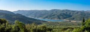 a view of a mountain valley with a lake at Country Hotel Velani in Avdou