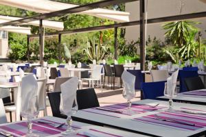 eine Gruppe von Tischen mit Servietten und Gläsern darauf in der Unterkunft Belambra Clubs La Colle-sur-Loup - Les Terrasses De Saint-Paul De Vence in La Colle-sur-Loup