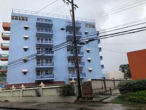 un gran edificio azul con ventanas delante en Hastings Towers 3D Studio Apt Opp Beach, en Bridgetown