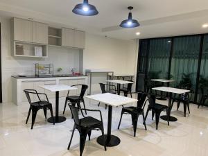 a group of tables and chairs in a kitchen at Icare Residence & Hotel in Bangkok