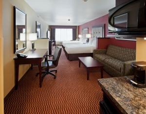 a hotel room with a couch and a bed at Holiday Inn Express and Suites Great Falls by IHG in Great Falls +21 photos