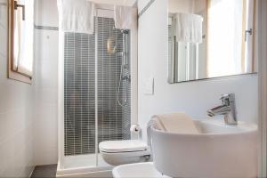 a bathroom with a toilet and a sink and a shower at Via Verdi B&B in Vago