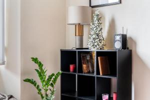 a black book shelf with a christmas tree on it at amazing apartments - Torphichen Place by Haymarket in Edinburgh
