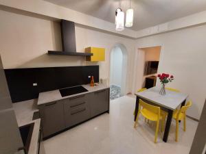 a kitchen with a table and yellow chairs at Residenza Donini in Venice Suite 2 in Venice