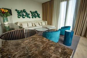 a living room with a couch and a table and chairs at Soho Boutique Catedral in Seville