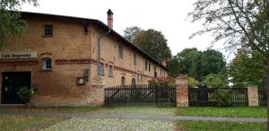 a brick building with a gate in front of it at 130qm-grosse-Ferienwohnung-am-Naturschutzgebiet-15-Min-bis-zum-Stettiner-Haff-PKW in Bugewitz