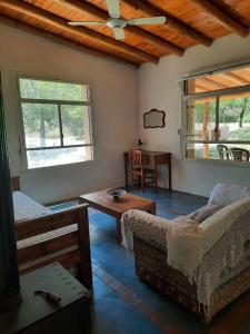 a living room with two beds and a table at La Roja y Barro tal vez in Los Molles
