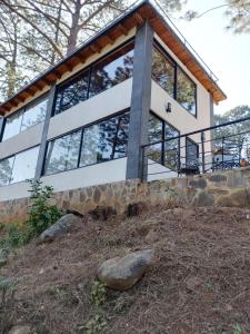 a house on a hill with a rock at Mazamitla Pinos del Rio in Mazamitla