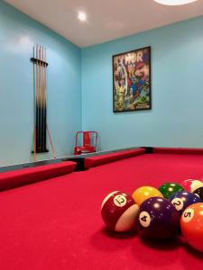 a billiard room with a red pool table with balls at La Grange Saillant Saint Nectaire in Saillant
