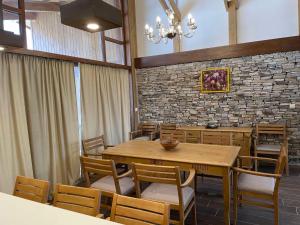 a dining room with a wooden table and chairs at Villa Tama Pirin Golf and Spa in Bansko