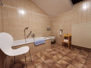 a bathroom with a tub and a toilet at Haus Bullachberg in Schwangau