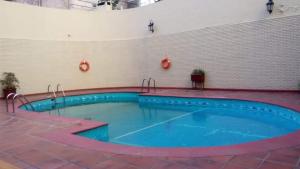 a large swimming pool with blue water in a building at Departamento de Gaby en Retiro in Buenos Aires
