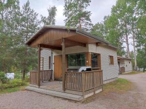 a small house with a porch and a deck at Heinolan Heinäsaari - Holiday and Camping in Heinola