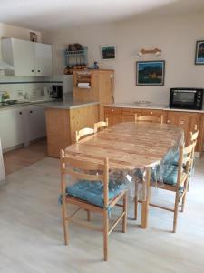 a kitchen with a wooden table and chairs at T2 Résidence de l'Ars Aulus les Bains in Aulus-les-Bains