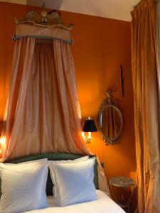 a bedroom with a canopy over a bed with white pillows at B&B The Verhaegen in Ghent