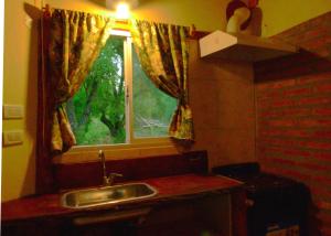 a kitchen with a sink and a window at Cabaña Cafuné in El Bolsón +17 photos