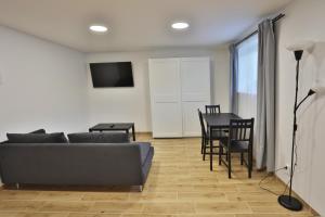 een woonkamer met een bank en een tafel bij River Park apartments Ukmerge in Ukmergė