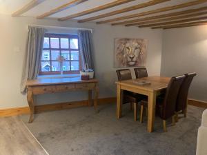 a dining room with a table and a desk at Apartment Two, The Carriage House, Bilbrough, York in York