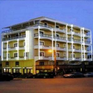 a large apartment building with a street light in front of it at Katerina Hotel in Kozani