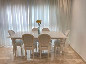阿加迪爾的住宿－AGADIR BAY - LUXURY APARTMENT NEAR BEACH，餐桌、椅子和花瓶