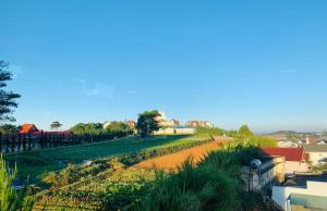 a view of a dirt road next to a field at Villa Délight House “Stay&Chill” in Da Lat
