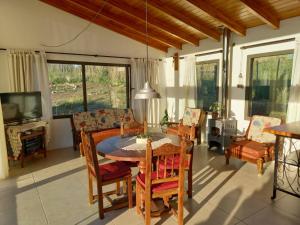 a dining room with a table and chairs at Cabaña La Joaquina - Villa Giardino in Villa Giardino