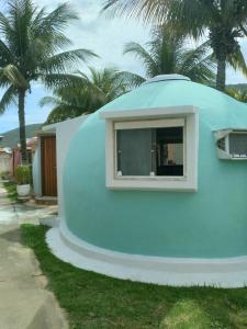 a blue dome house with a window on the side of it at Cabanas de Tucuns in Búzios