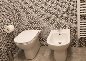 a bathroom with a toilet and a bidet at La Francigena - Trebbia House in Piacenza +7 photos