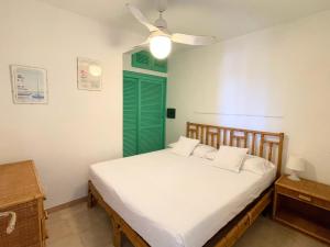 a bedroom with a bed with a green shutter at Casa Leo - Villaggio Baia De Bahas in Golfo Aranci