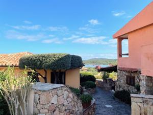 a house with bushes on the side of it at Casa Leo - Villaggio Baia De Bahas in Golfo Aranci