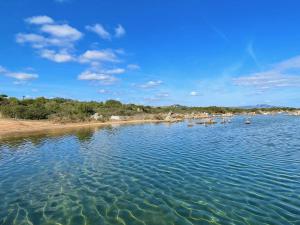 a large body of water with boats in it at Casa Leo - Villaggio Baia De Bahas in Golfo Aranci