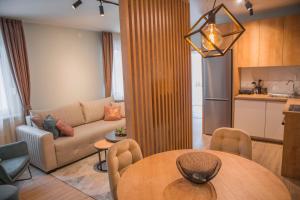 a kitchen and a living room with a table and a couch at Mountain angels in Kolašin