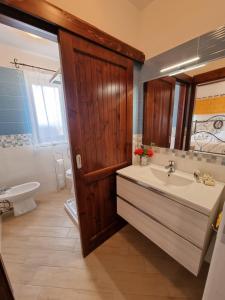 a bathroom with a sink and a tub and a toilet at Agriturismo Finagliosu in Palmadula +74 photos