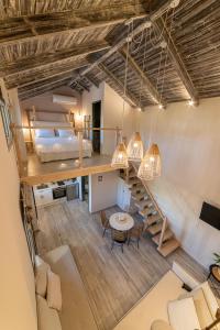 a loft apartment with a bed and a table and chairs at Perla Luxury Living in Parga +53 photos
