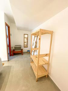a room with a wooden shelf against a wall at Pousada Brisa Mar in Fernando de Noronha