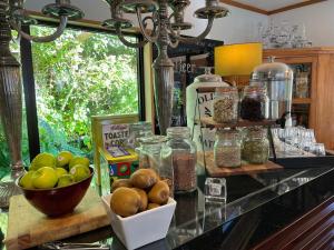 a counter with bowls of apples and jars of food at The Embassy B&B in Queenstown