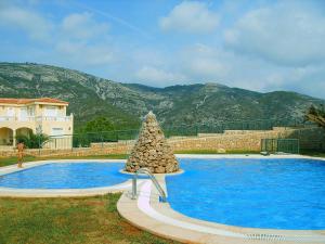 a swimming pool with a christmas tree in front of a house at Atico Mirador al Mar in Alcossebre