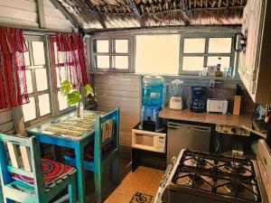 een kleine keuken met een tafel en een fornuis bij Beachfront Casa Maya Lodge in El Cuyo