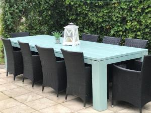 a blue table and chairs on a patio at Groepsaccomodatie Tzummarum in Tzummarum